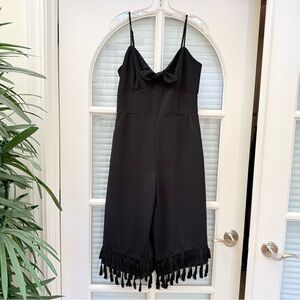Black Jumpsuit with Decorative Bow Tie and Fringe Accents.